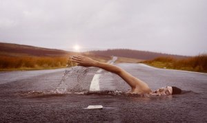 strange dream example shown in a person swimming through the asphalt of the road